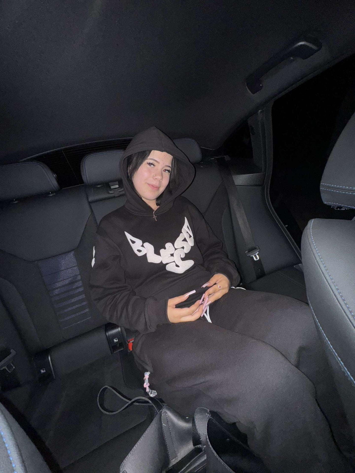 Full Blessed tracksuit worn in a car